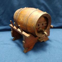 Vintage oak barrel rimmed with brass on its support