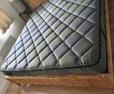 Super King mattress with wooden bed