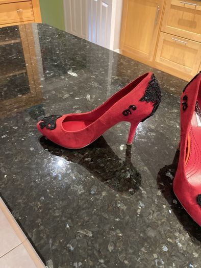 Red high heeled shoes with black lace