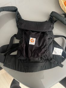 Black Ergobaby Omni 360 Baby Carrier featuring adjustable waist snaps on the front