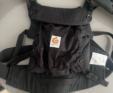 Black Ergobaby Omni 360 Baby Carrier featuring adjustable waist snaps on the front