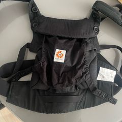 Black Ergobaby Omni 360 Baby Carrier featuring adjustable waist snaps on the front