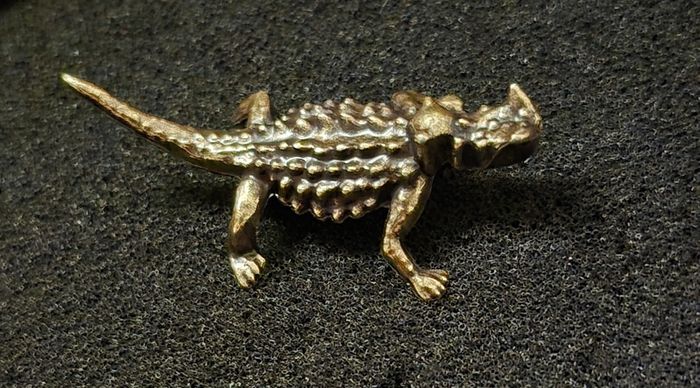3 brass lizards.