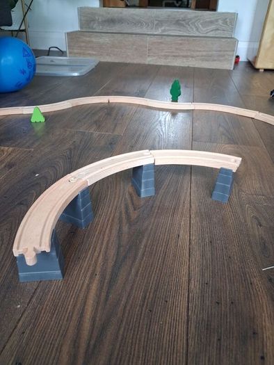 wooden train track set with wooden trains and accessories.