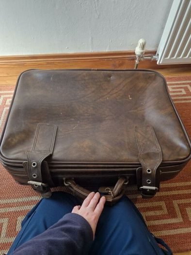 1leather suitcase and 1 faux leather suitcase.