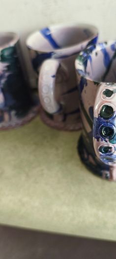 Set of 4 Irish pottery mugs featuring blue and green marbled glazes