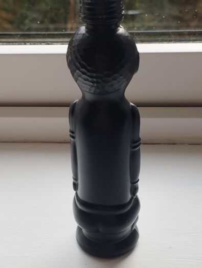 Vintage miniature "VUDU" bottle made of opaque black glass.