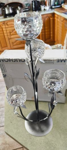 4-arm Flower  crystal tealight candle holder with a metal stand.