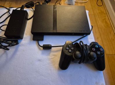 Play Station 2 super slim + DualShock 2 + Charlie game