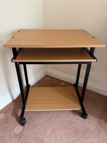 Computer desk with sliding shelf on wheels