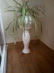 White ceramics pedestal planter with embossed floral and leaf motifs