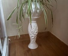 White ceramics pedestal planter with embossed floral and leaf motifs