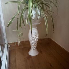 White ceramics pedestal planter with embossed floral and leaf motifs