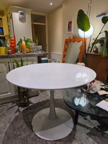 Classic mid-century / Space Age white tulip dining table with a heavy metal pedestal base