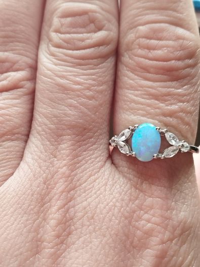 Ring made of 925 silver with oval opal of blue shade and cubic zirconia.