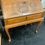 This is a vintage mid-20th-century Asian carved wood writing bureau featuring an intricate hand-carved traditional landscape on the drop-front lid. Image 2