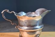Antique silver cream jug with scalloped rim
