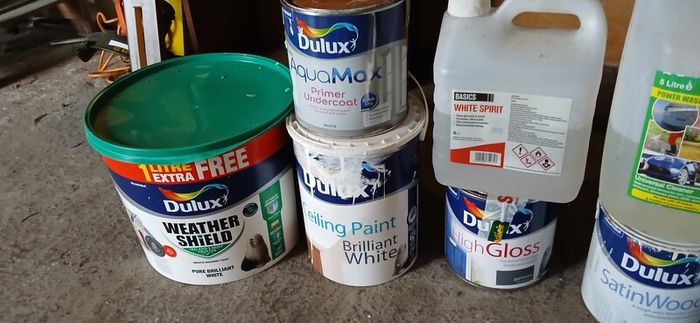 a selection of paint and a paint roller and some good paint brushes