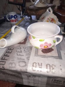 His and Hers Old Ceramic Chamber Pots hand painted floral chamber pot with side handle, together with a white glazed shaped bottle featuring scroll handle and narrow spout