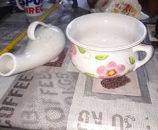 His and Hers Old Ceramic Chamber Pots hand painted floral chamber pot with side handle, together with a white glazed shaped bottle featuring scroll handle and narrow spout