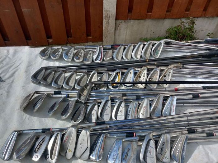 A selection of Golf clubs. Bags and golf balls.