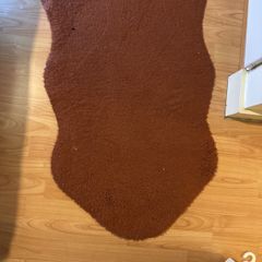 Brick-red fur rug