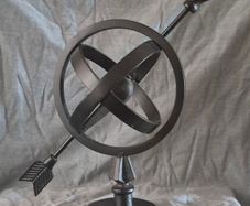 Metal globe and arrow.