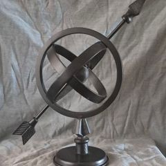 Metal globe and arrow.