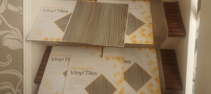 Greyish stick on Vinyl floor tiles  6 unused packs available