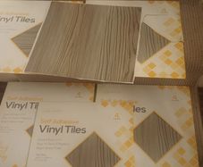 Greyish stick on Vinyl floor tiles  6 unused packs available