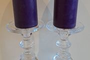 2 large glass candle sticks with candles