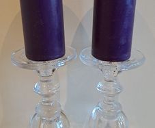 2 large glass candle sticks with candles