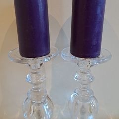 2 large glass candle sticks with candles