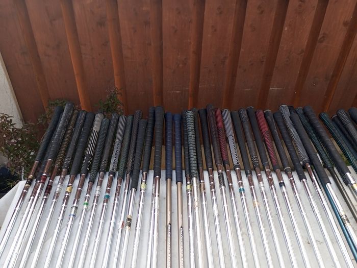A selection of golf clubs and bags. All right handed clubs.