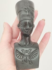 A vintage statuette of the Nefertiti bust.
