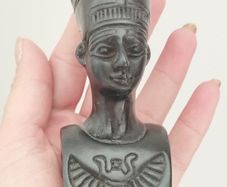 A vintage statuette of the Nefertiti bust.