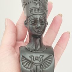 A vintage statuette of the Nefertiti bust.