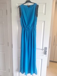 Ladies vibrant blue full-length dress with sleeve detail and back detail.