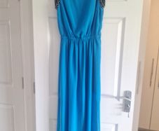 Ladies vibrant blue full-length dress with sleeve detail and back detail.