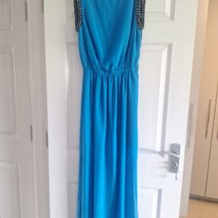 Ladies vibrant blue full-length dress with sleeve detail and back detail.