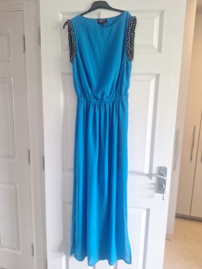 Ladies vibrant blue full-length dress with sleeve detail and back detail.
