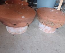 Vintage terracotta chimney cowls and wire bird guard
