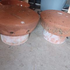 Vintage terracotta chimney cowls and wire bird guard