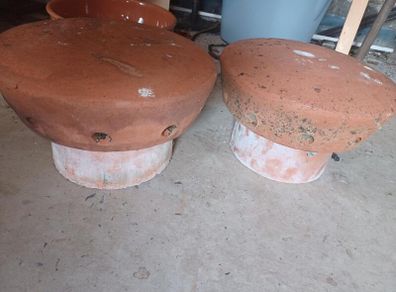 Vintage terracotta chimney cowls and wire bird guard