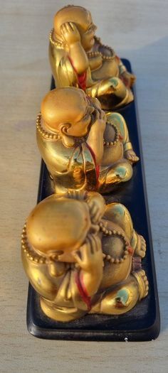 Three brass Buddha figurines