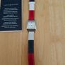 Tommy Hilfiger watch features a distinctive rectangular stainless steel case and a reversible red, white, and blue leather strap Image 2