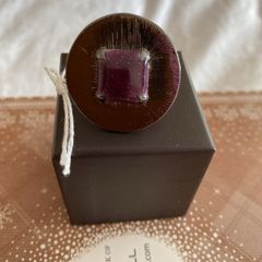 Ring with purple centre stone, signed IKITA