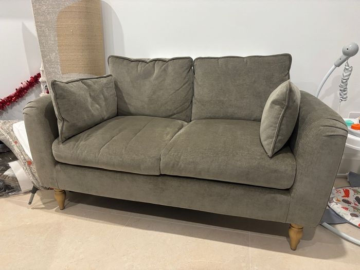 Sage green sofa ideal for small spaces