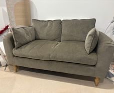 Sage green sofa ideal for small spaces