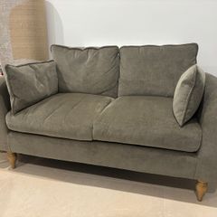 Sage green sofa ideal for small spaces